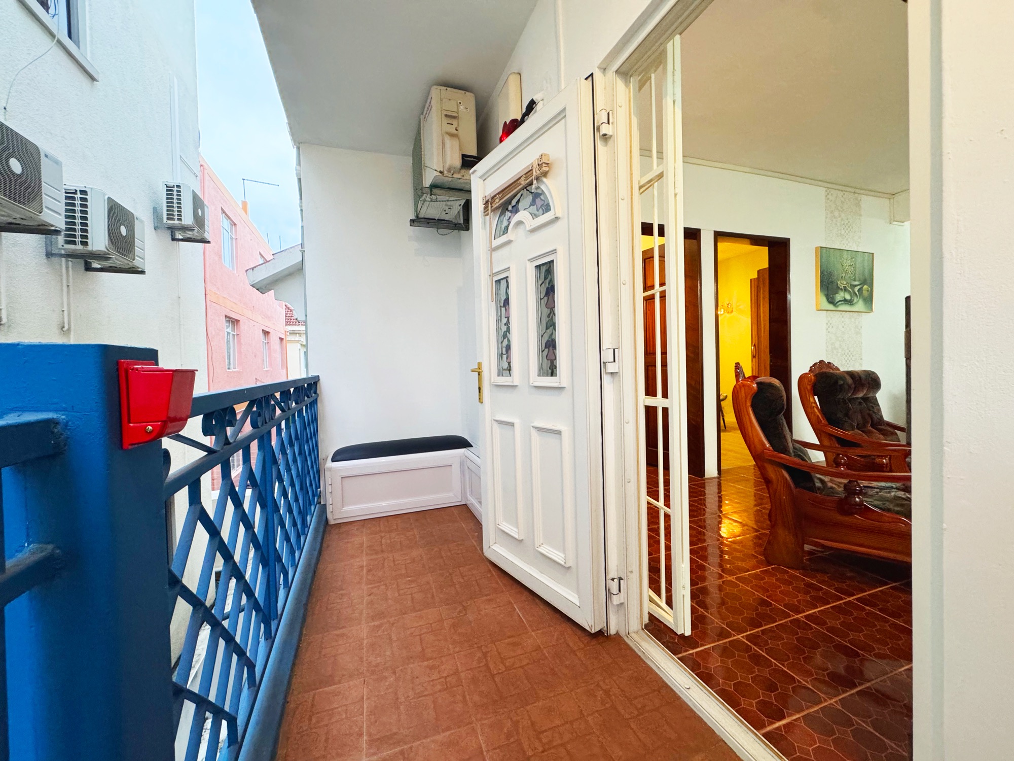 Outdoor balcony seating beside the second entrance